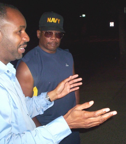 Greg Smith, left, confers with Donny Elder at the beginning of a nightly parent patrol in the Dwight neighborhood.