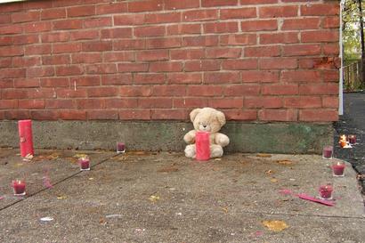 Neighbors made a memorial for Toby White on the sidewalk outside 12 Kensingston St.