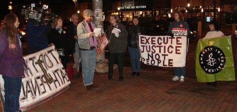 Stephen Kobasa and reads a statement written by Joan Cavanagh (to his left) at Thursday's demonstration.