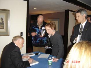 Roseanne Zudekoff of the Albertus development office lines up to buy a copy of the book by the author and motivational speaker, Dennis Perkins