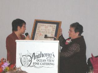 Mrs. Harold Gabucci presented a plaque to co-honoree Rita DeNegre.